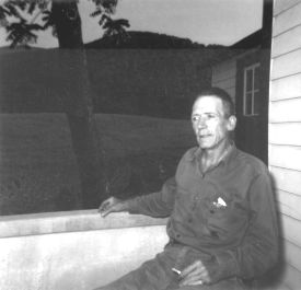 Raz's Robert on front porch with mountains, evening